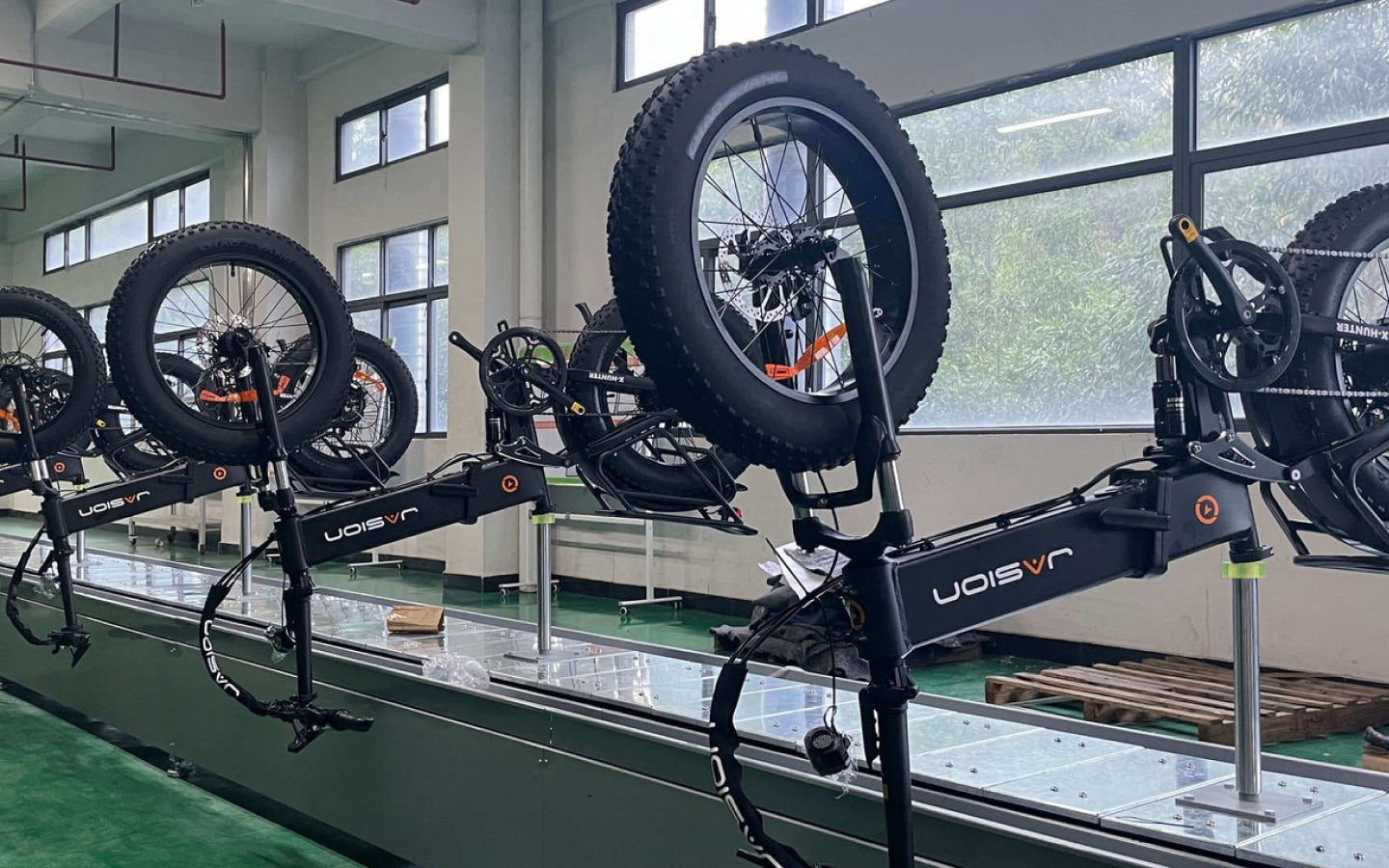 JasionBike electric bikes on a workshop rack